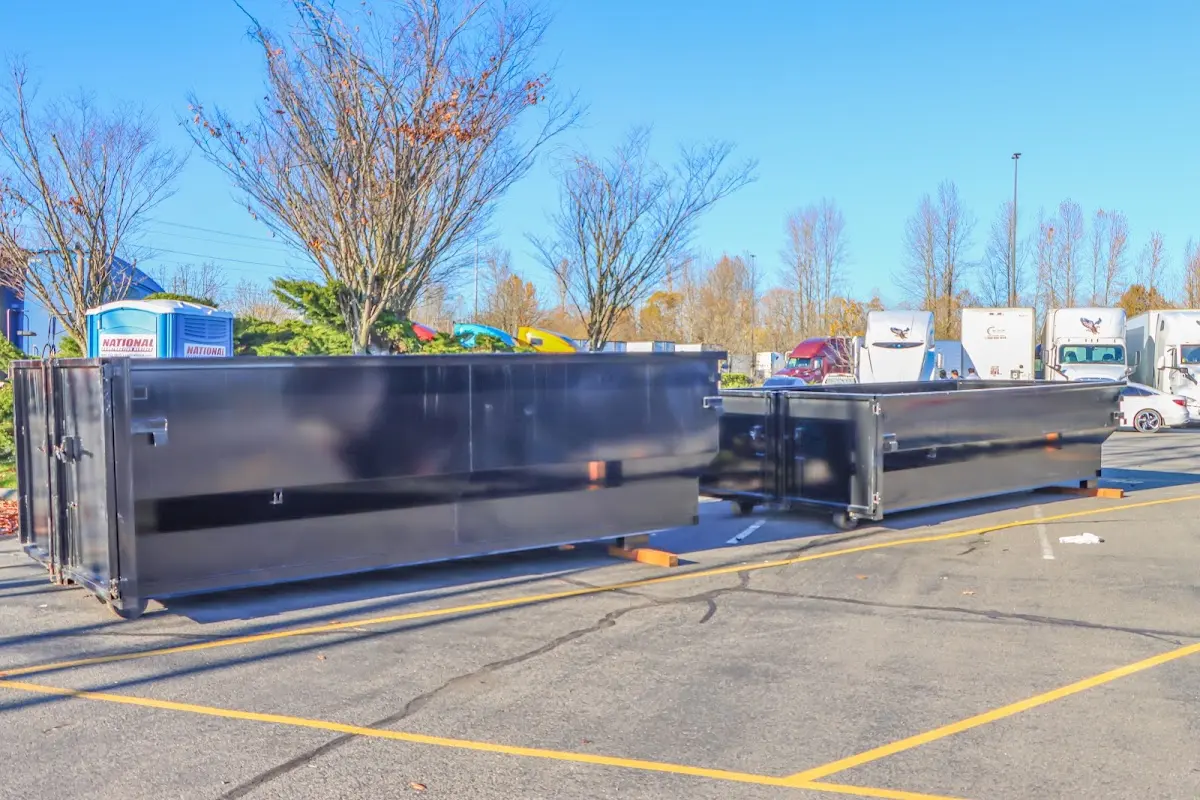 Professional dumpster rental service with roll-off container on residential driveway in Pocatello